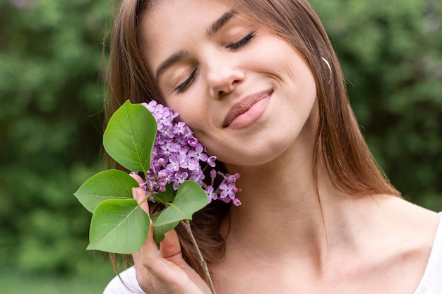 Woman with lilac branch