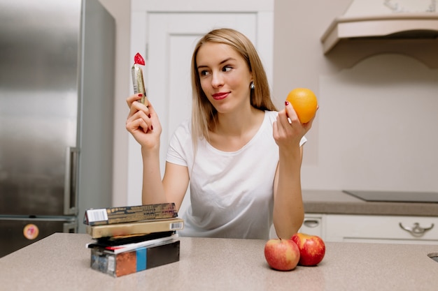 woman with lipstick and apples in kitchen