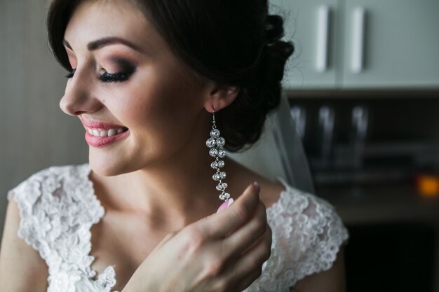 Free photo woman with long earrings and a white dress