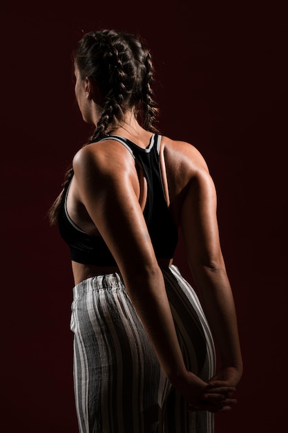 Woman with long hair in dark background from behind shot