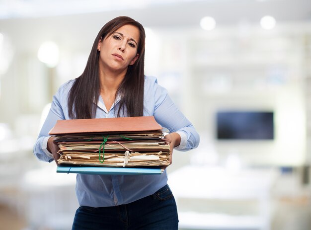 Woman with lots of papers and folders