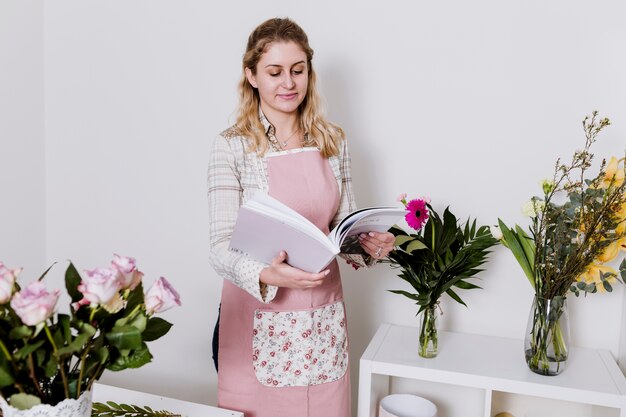 Woman with magazine in flower shop