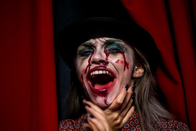 Woman with make-up as blood laughing