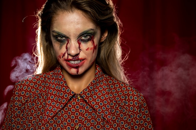 Free photo woman with make-up as blood smirking