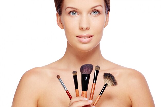 Woman with makeup brushes