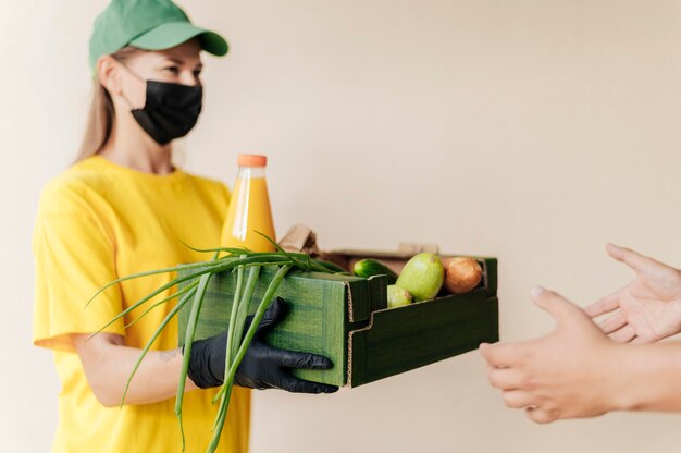 Woman with mask delivering order