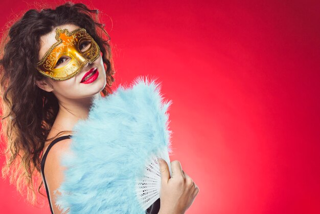 Woman with mask and fan