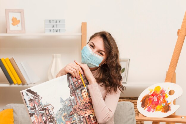 Woman with mask holding picture