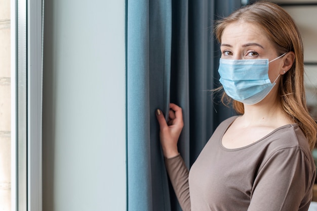 Woman with mask in quarantine medium shot