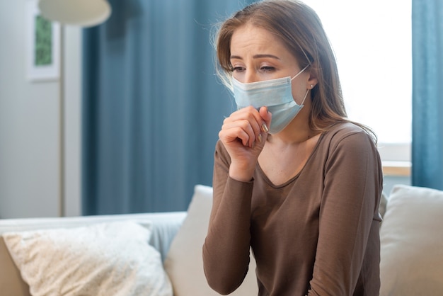 Woman with mask staying in quarantine and coughing