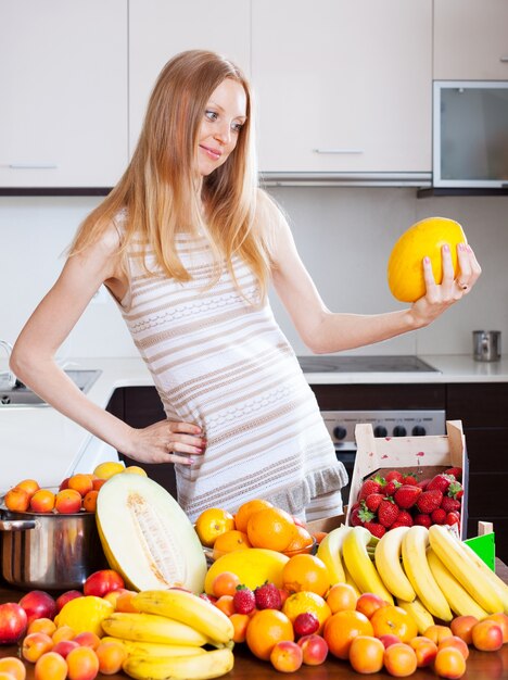 woman with melon and other fruits