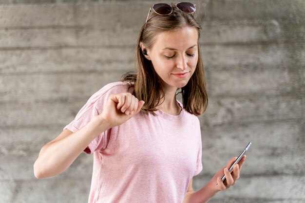 Woman with mobile dancing