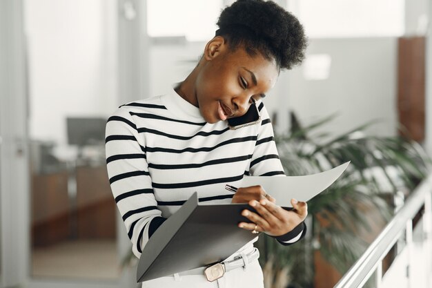 Woman with mobile phone. Lady with documents.