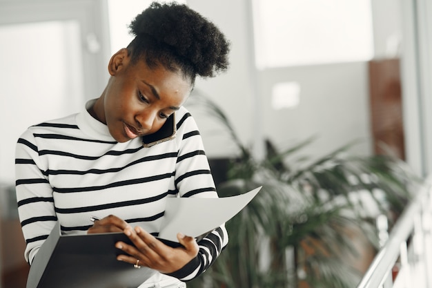 Woman with mobile phone. Lady with documents.