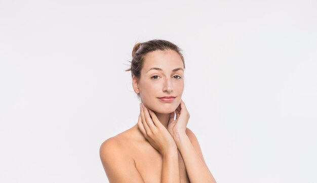 Woman with naked shoulders touching neck