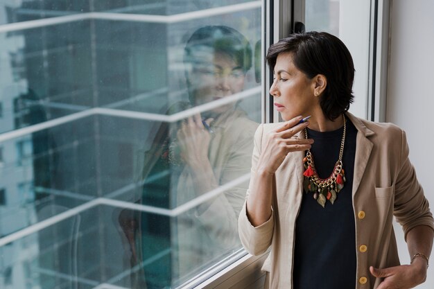 Woman with necklace looking away medium shot