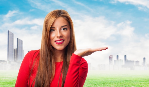 Woman with an open hand and the city in the distance