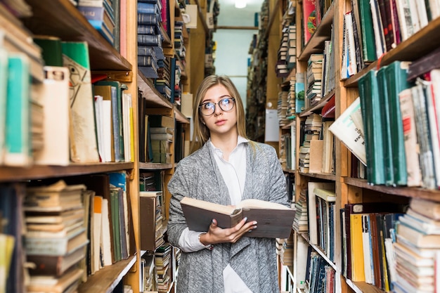 Woman with opened book looking up