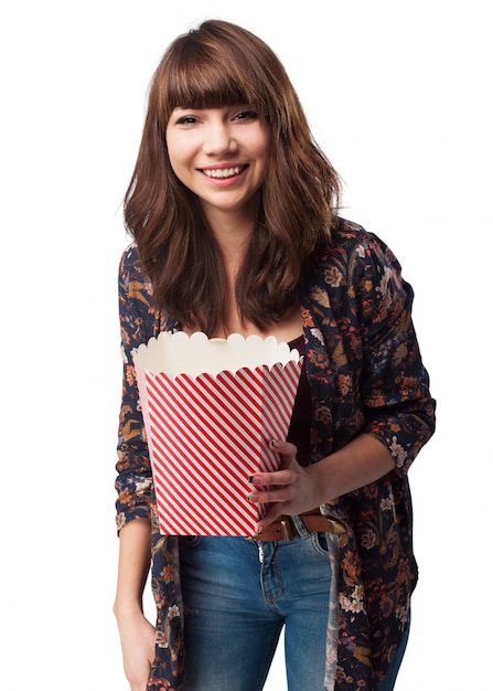 Woman with a packet of popcorn