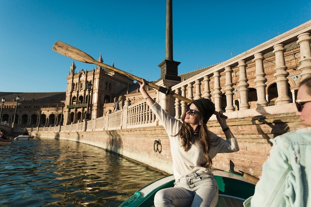 Free photo woman with paddle on boat