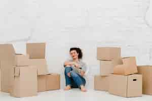 Free photo woman with paint roller near boxes