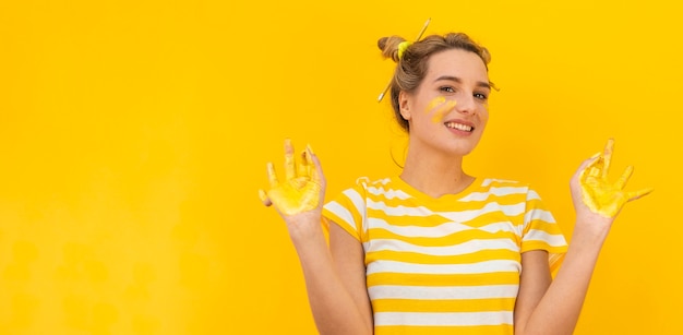 Woman with painted hands smiling