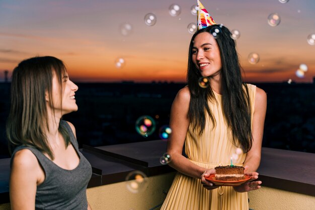 Woman with party hat on rooftop party