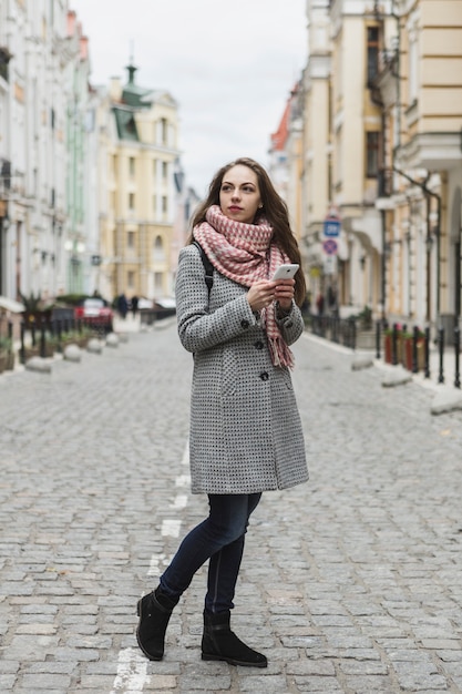 Free photo woman with phone on street