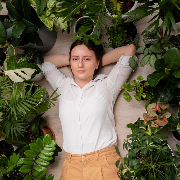 Free photo woman with plants frame