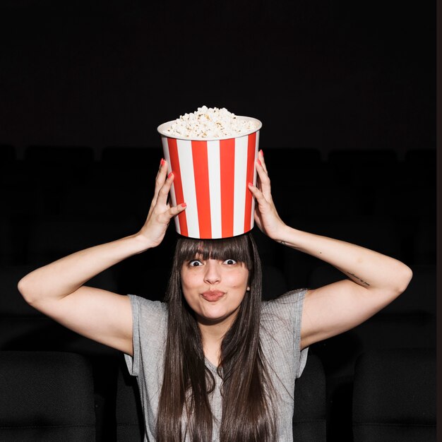 Woman with popcorn in cinema