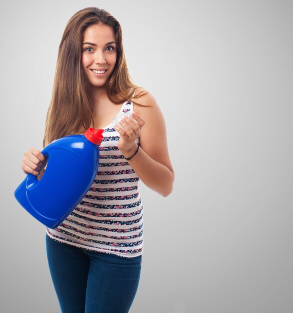 Woman with a pot of blue detergent