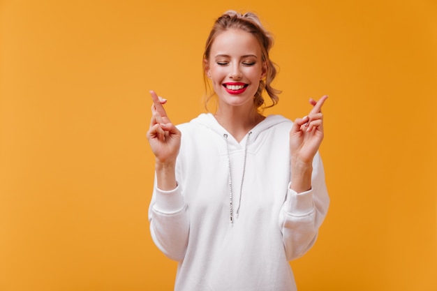 Woman with pretty dimples on her cheeks with smile makes wish