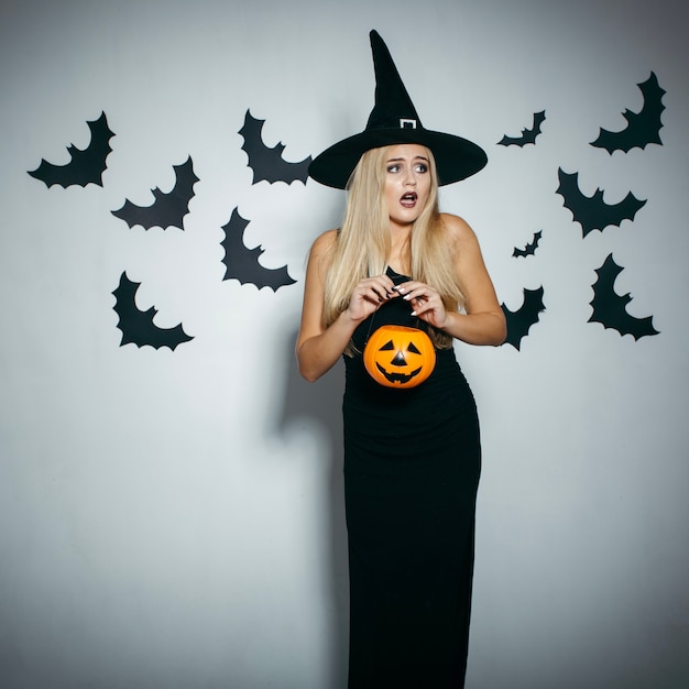 Woman with pumpkin feeling fear
