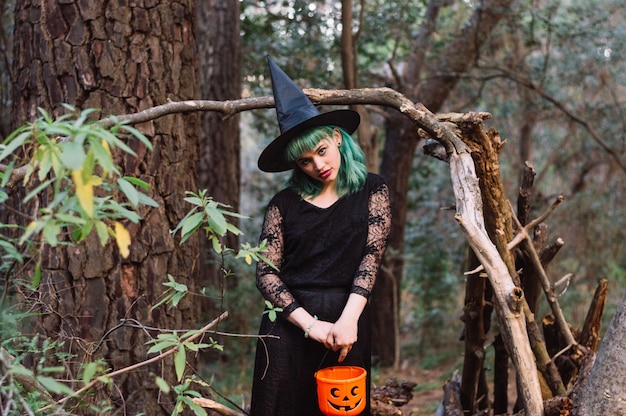 Woman with pumpkin in woods