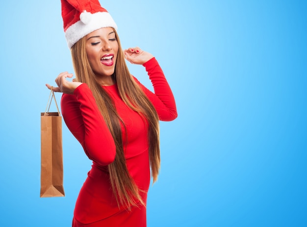 Woman with a purchase bag in a blue background