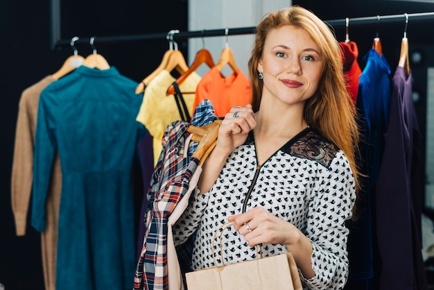 Woman with purchases in shop