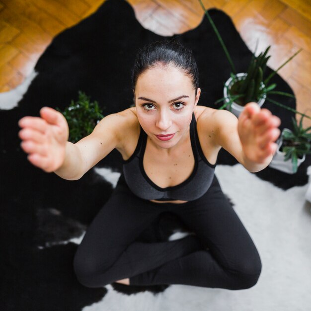 Woman with raised hands looking at camera