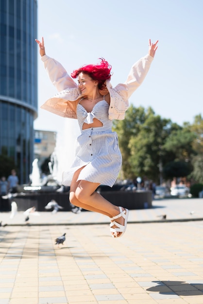 Woman with red hair jumping