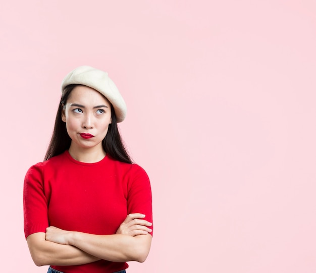 Woman with red lips standing with arms crossed