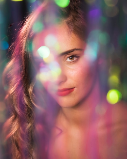 Woman with red lipstick and blurred sparkles effect