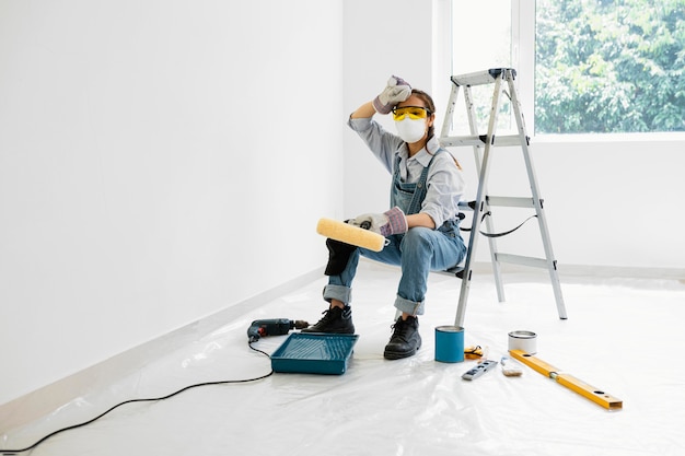Woman with safety protection equipment painting
