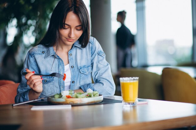 Woman with salad and phone