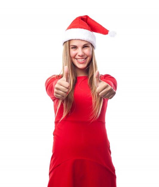 Woman with santa claus hat showing thumbs up