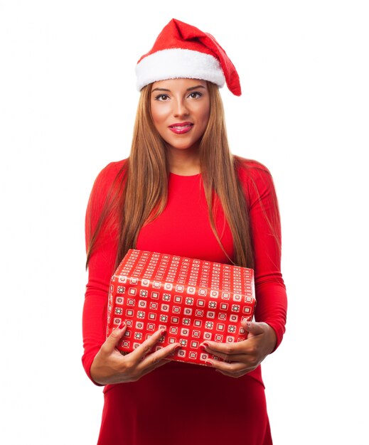 Woman with santa hat and a gift in her hands