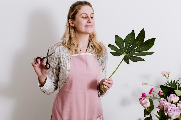 Woman with scissors and leaf