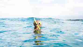 Free photo woman with scuba gear swimming in the ocean