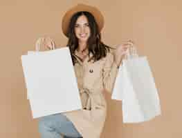 Free photo woman with shopping bags in both hands