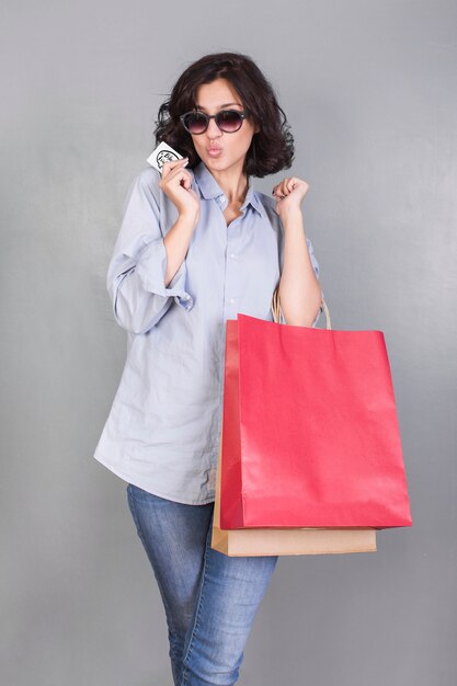 Woman with shopping bags making air kiss