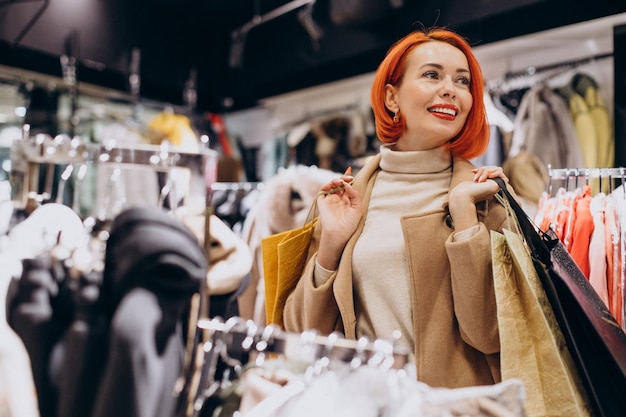 Woman with shopping bags making purchases in mall