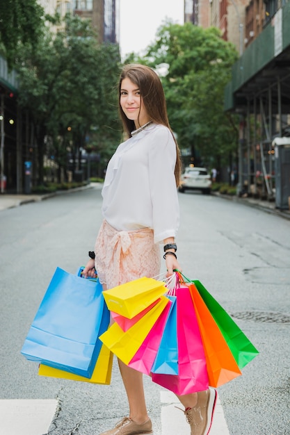 Woman with shopping bags on road